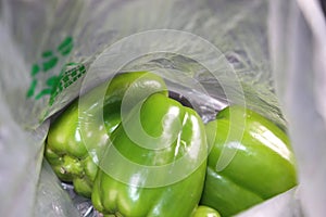 Inside a grocery bag - fresh green peppers