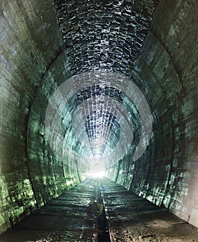 Inside of a grungy tunnel photo