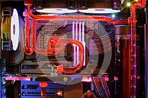 Inside high performance Desktop PC and water cooling system on CPU socket with multicolored LED RGB neon light show status on work