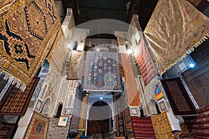 Inside interior of Carpet shop with colourful moroccan rugs and berber carpets on display in a souk market in the centre of medina