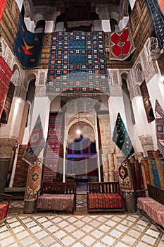 Inside interior of Carpet shop with colourful moroccan rugs and berber carpets on display in a souk market in the centre of medina