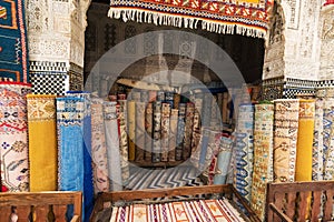 Inside interior of Carpet shop with colourful moroccan rugs and berber carpets on display in a souk market in the centre of medina