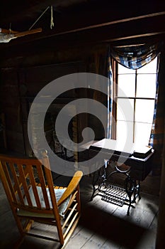 Inside Log Cabin with Rocking Chair by Window photo