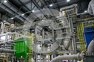 Inside modern Chemical factory production line. Industrial equipment, cables, vats and piping