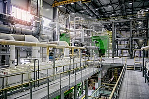 Inside modern Chemical factory. Thermoplastic production line. Industrial equipment, cables, vats and piping