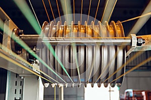 Inside a modern plant producing power electric cables and optical fibers. .Cable manufacturing machine part.