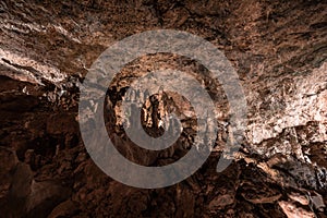 Inside the mysterious flowstone cave `NebelhÃ¶hle` with stalagmites and stalactites in Germany