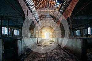 Inside old abandoned German stable or barn with horse boxes