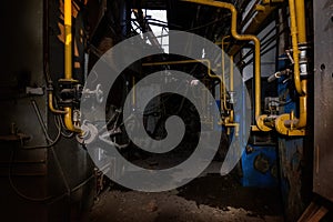 Inside old collapsed industrial building. Old rusty pipeline
