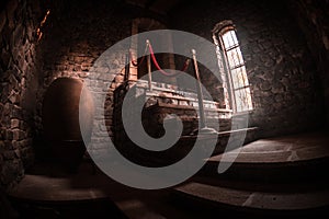 Inside of old creepy abandoned mansion. Staircase and colonnade. Dark castle stairs to the basement. Spooky dungeon stone stairs