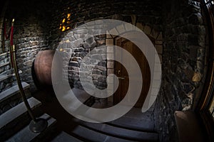 Inside of old creepy abandoned mansion. Staircase and colonnade. Dark castle stairs to the basement. Spooky dungeon stone stairs