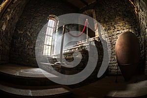 Inside of old creepy abandoned mansion. Staircase and colonnade. Dark castle stairs to the basement. Spooky dungeon stone stairs