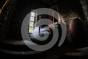 Inside of old creepy abandoned mansion. Staircase and colonnade. Halloween pumpkin on dark castle stairs to the basement.