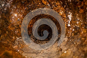 inside old dirty sewer line pipe. rusty casting iron drain tube