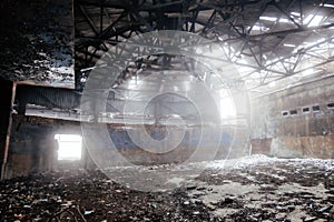 Inside old ruined abandoned industrial building in the fog