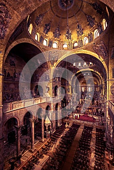 Inside the old St Mark`s Basilica or San Marco, it is top landmark of Venice. Golden mosaic interior of ornate Saint Mark`s