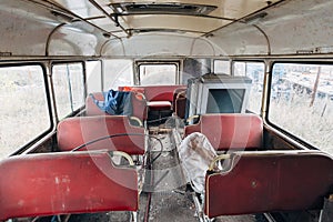 Inside old time abandoned Soviet bus. Old dirty seats