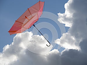 Inside out umbrella in gust of wind, sky behind.