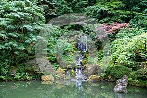 Inside a peaceful japanese garden, a Japanese pagoda rock statue in Portland