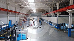 Inside the plant for the production of steel materials. Scene. Modern manufacturing storage with machine tools, roller