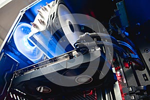 Inside of a professional gaming computer, video graphics card mounted on a motherboard/mainboard, blue shining fan - Bilder photo