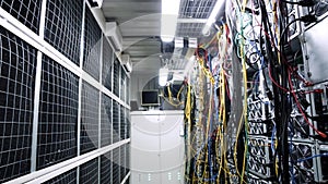 Inside room with data centers and cables. Stock footage. Room with data centers, cables and solar panels to absorb