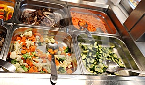 self service restaurant with many raw and cooked foods photo