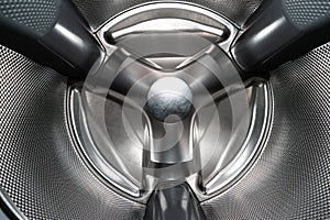 Inside shot of empty silver washing machine drum wide angle view