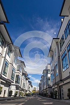 Inside of townhouse complex. townhomes are side by side. Rows of townhomes side by side. External facade of a row of colorful mode