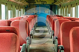 The inside of a train car is empty and mostly red