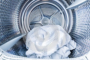 Inside of tumble dryer with clean white towels - new generation of dryer