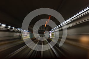 Inside tunel blur abstract scene traveling by train looking forward