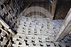 The inside of a very old dovecote, showing the ancient wooden beams and roof structure, and the dove nesting holes
