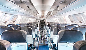 Inside view of commercial airplane with lonely man traveler - Emergency travel concept about flight cancellation - Aerospace