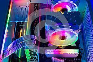 Inside view of custom colorful illuminated bright rainbow RGB LED gaming pc. Computer power hardware and technology concept