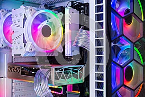 Inside view of custom colorful illuminated bright rainbow RGB LED gaming pc. Computer power hardware and technology concept