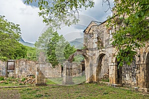 Inside view of an old monastery, made of stone and without a roof. photo