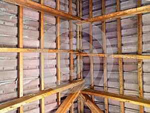 Inside view of tiled roof with wooden rafters
