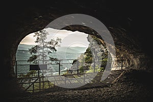 Inside view to nature landscape from hole of cave at mountain top