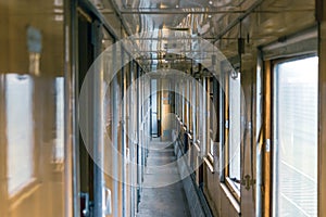 Inside of vintage train wagon. Corridor with wooden cabins.