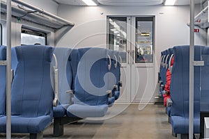 Inside The Wagon Train. Empty train interior. interior view of corridor inside passenger trains with blue fabric seats