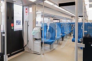Interior of the passenger train with empty blue fabric seats