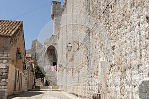 Inside wall of medieval city high wall leads to steps washing hanging in sun drying