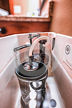 Inside water tank of toilet with float raised