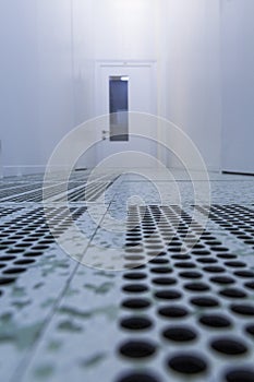 Inside white sterile cleanroom .Hallway with raised floor and door in cleanroom for pharmaceutical or electronic semiconductor