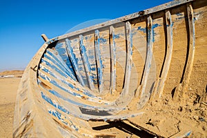 Inside of a wooden boat wrack in desert photo