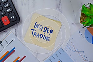 Insider Trading write on sticky notes isolated on Wooden Table