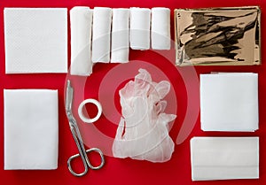 Insides of a First-Aid kit isolated on a red background