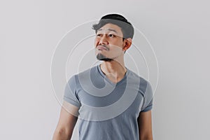 Insolent denying face of man in blue t-shirt isolated on white background.