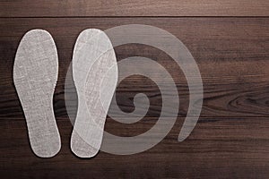 Insoles for shoes on wooden background